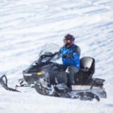 image of person on snow mobile.