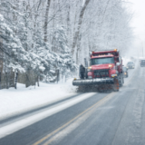 Image of a snow plow on a snowy road